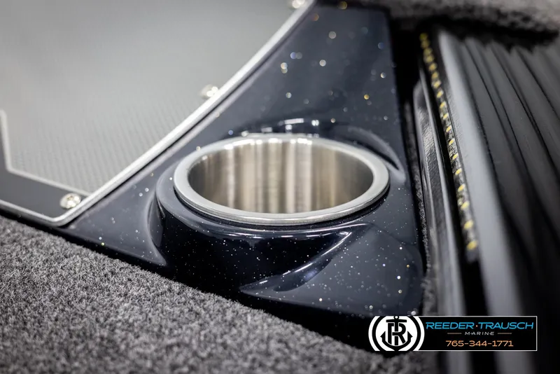 Slide: The Image of 2025 Lund 1875 Pro V Bass XS boat cup holder detail with Reeder-Trausch Marine logo. - 31