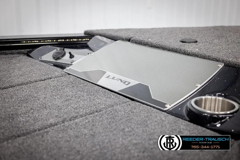 Slide: The Image of 2025 Lund 1875 Pro V Bass XS boat deck with carpet and cup holder. - 33
