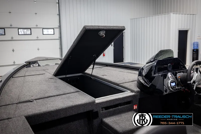 Slide: The Image of 2025 Lund 1875 Pro V Bass XS boat interior with open storage compartment in showroom. - 35