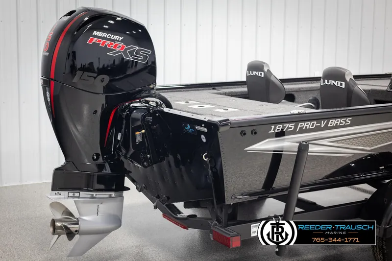 Slide: The Image of 2025 Lund 1875 Pro V Bass XS boat with Mercury Pro XS engine, displayed indoors. - 37