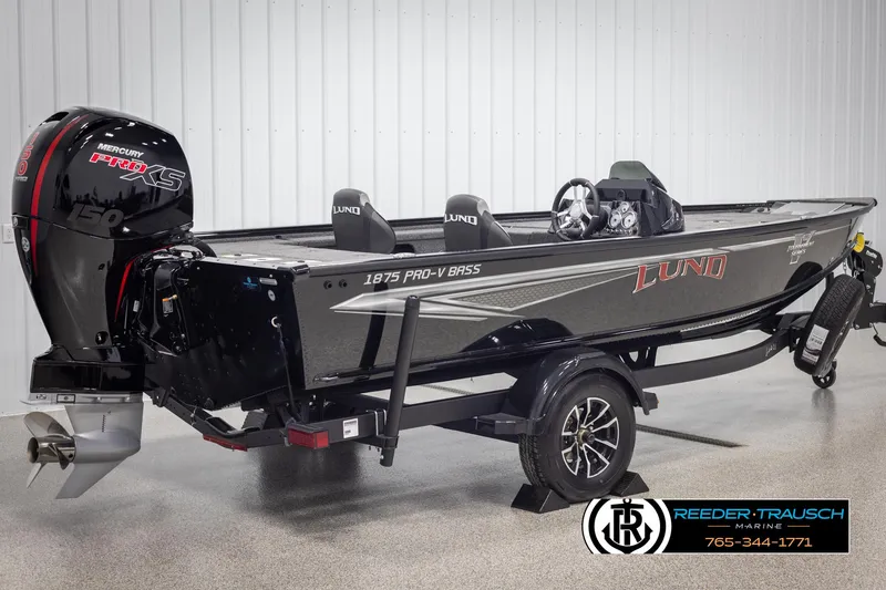 Slide: The Image of 2025 Lund 1875 Pro V Bass XS boat with Mercury Pro XS engine, displayed indoors. - 4