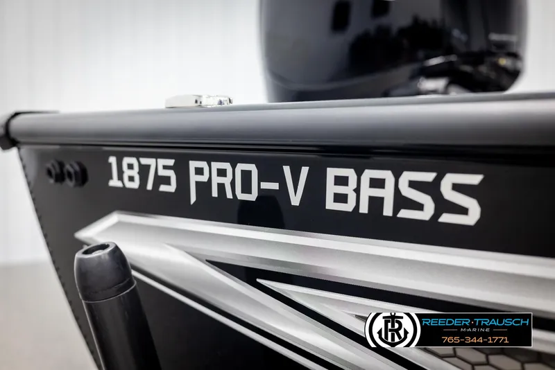 Slide: The Image of 2025 Lund 1875 Pro V Bass XS boat, close-up view with branding and logo. - 43