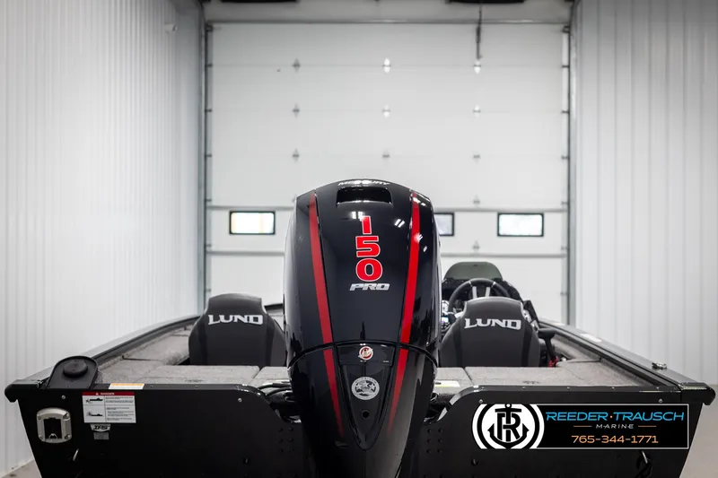Slide: The Image of 2025 Lund 1875 Pro V Bass XS boat with 150 Pro motor in a garage. - 5