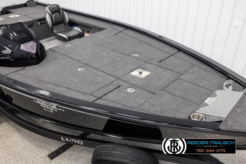 Slide: The Image of 2025 Lund 1875 Pro V Bass XS boat interior with carpeted deck and seating. - 7