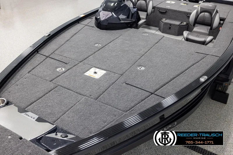 Slide: The Image of 2025 Lund 1875 Pro V Bass XS boat interior with gray carpet and seating. - 8