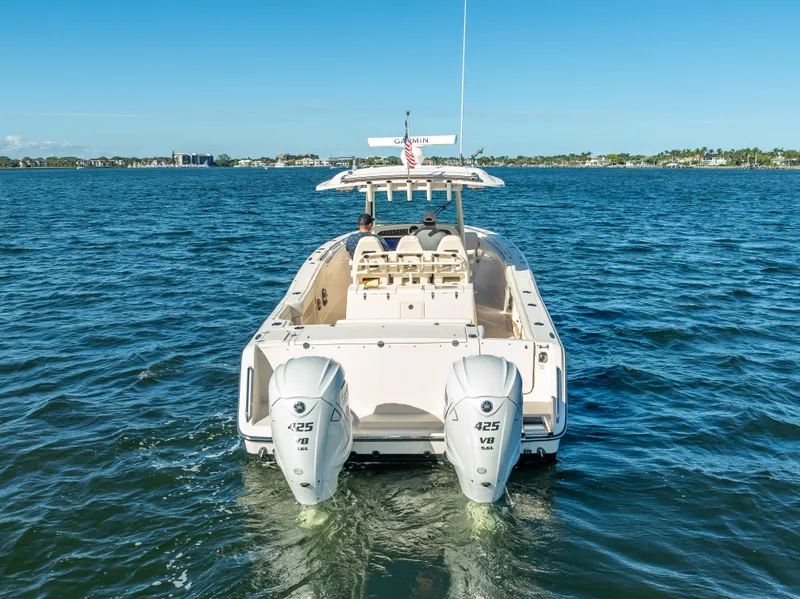 Slide: The Image of 2023 Grady-White 336 Canyon boat on open water, rear view with dual engines. - 10