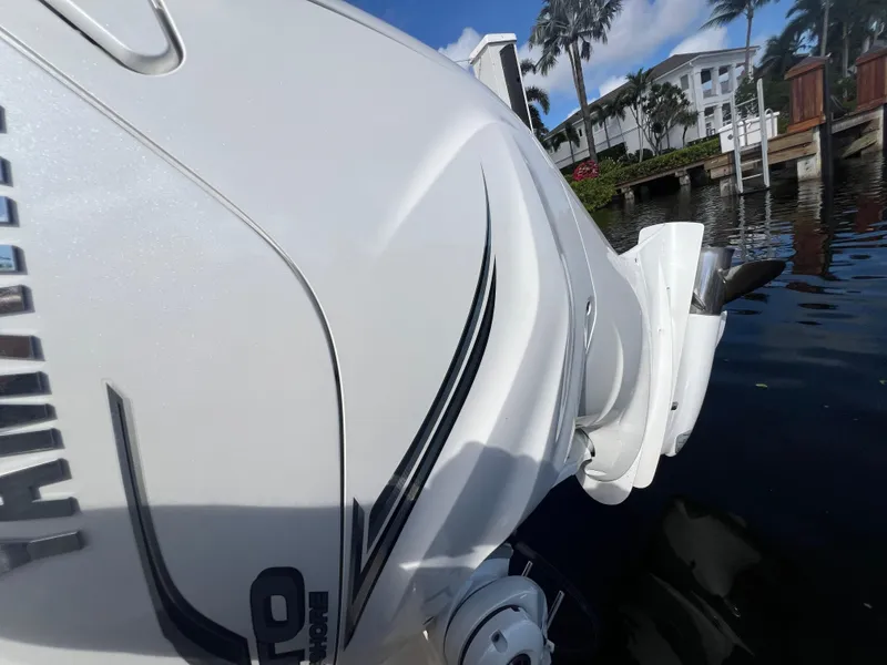 Slide: The Image of Close-up of 2023 Grady-White 336 Canyon boat engine near dockside. - 103