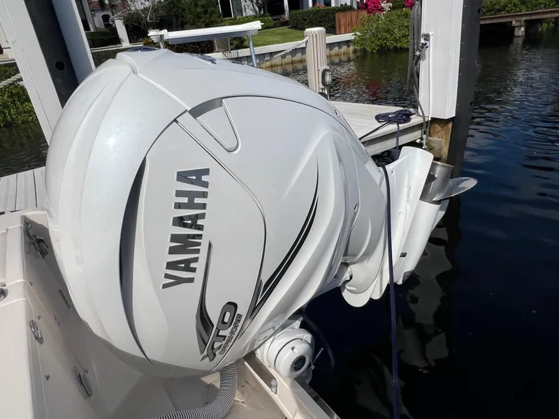 Slide: The Image of Yamaha outboard motor on 2023 Grady-White 336 Canyon boat docked by water. - 104