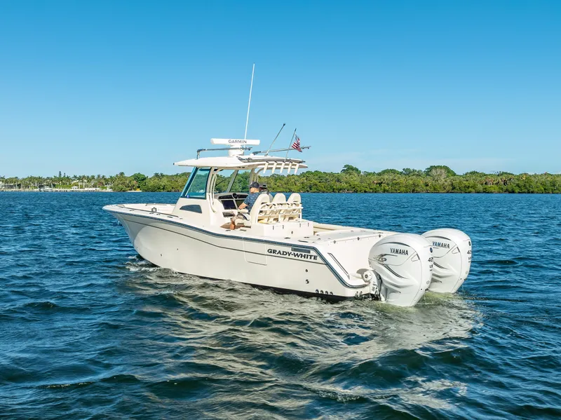 Slide: The Image of 2023 Grady-White 336 Canyon boat cruising on a sunny day. - 11