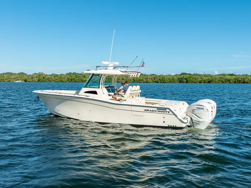 Slide: The Image of 2023 Grady-White 336 Canyon boat cruising on a sunny day. - 12