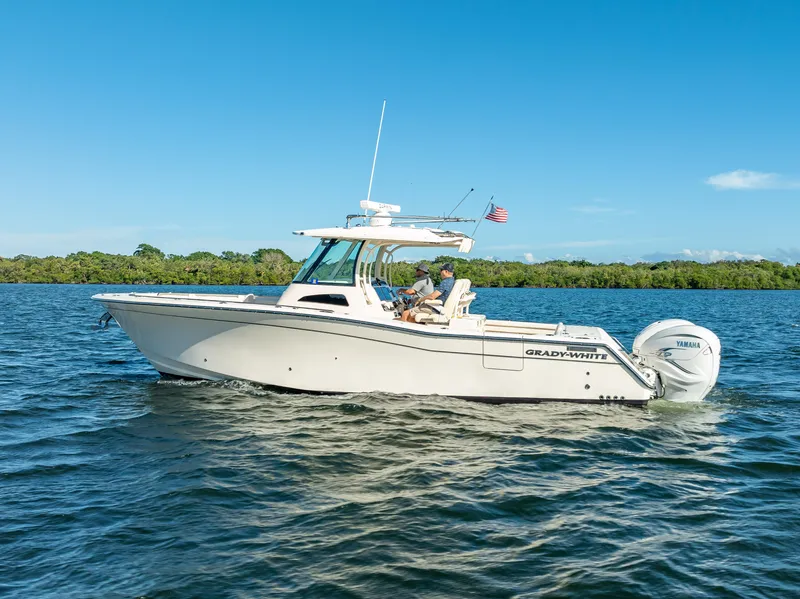 Slide: The Image of 2023 Grady-White 336 Canyon boat cruising on a sunny day. - 13