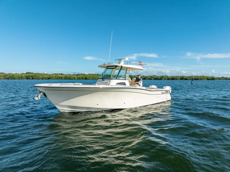 Slide: The Image of 2023 Grady-White 336 Canyon boat cruising on a sunny day. - 14