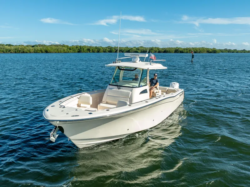 Slide: The Image of 2023 Grady-White 336 Canyon boat cruising on a sunny day. - 15