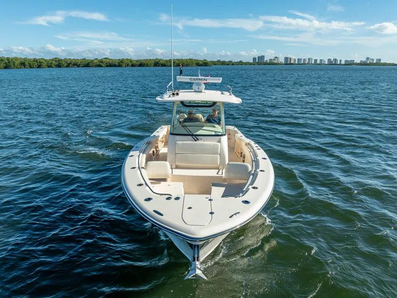 Slide: The Image of 2023 Grady-White 336 Canyon boat cruising on open water under clear skies. - 16
