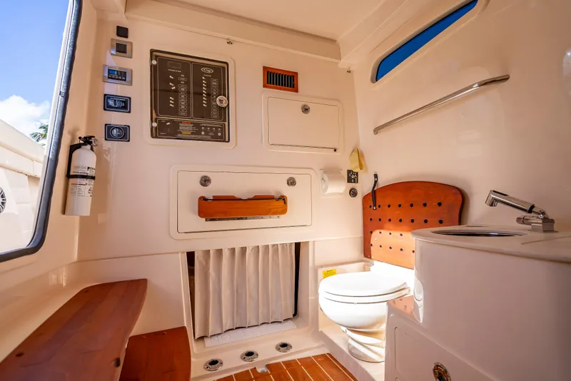 Slide: The Image of 2023 Grady-White 336 Canyon boat interior with bathroom and control panel. - 17