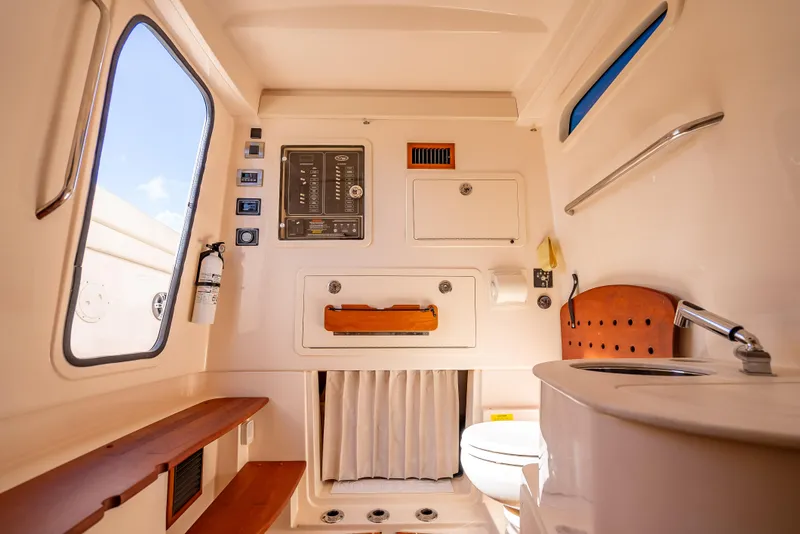 Slide: The Image of 2023 Grady-White 336 Canyon cabin interior with control panel and amenities. - 19