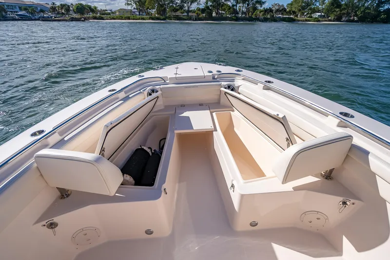 Slide: The Image of 2023 Grady-White 336 Canyon boat interior with seating and storage on the water. - 25
