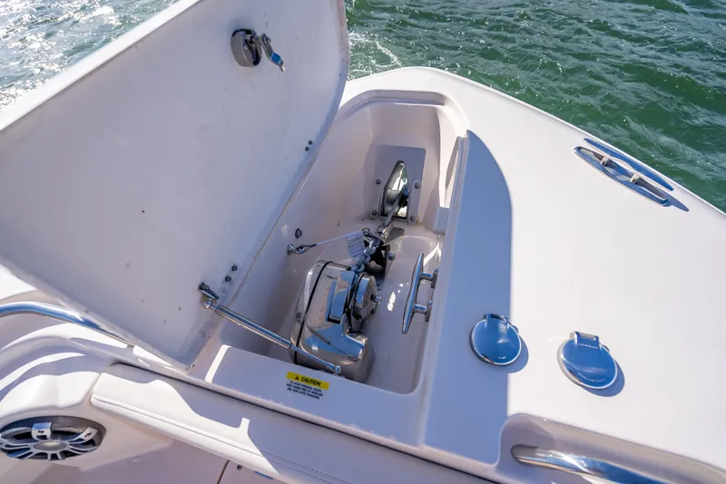 Slide: The Image of Anchor compartment of 2023 Grady-White 336 Canyon boat on water. - 26