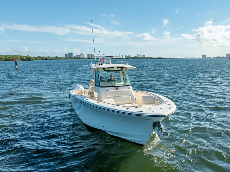 Slide: The Image of 2023 Grady-White 336 Canyon boat cruising on a sunny day. - 3