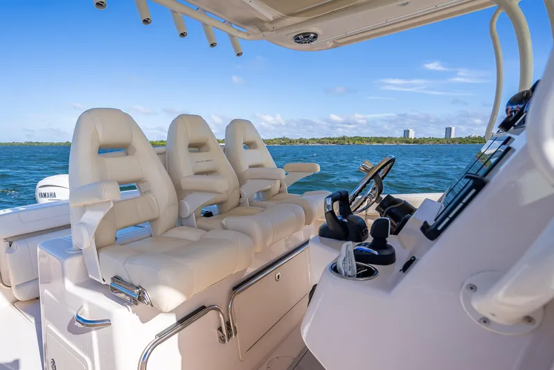 Slide: The Image of 2023 Grady-White 336 Canyon boat interior with luxurious seating and steering console. - 30
