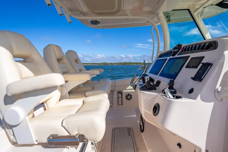 Slide: The Image of 2023 Grady-White 336 Canyon boat interior with luxurious seating and advanced navigation system. - 31