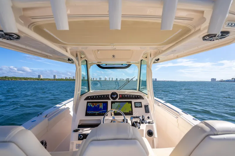 Slide: The Image of 2023 Grady-White 336 Canyon boat interior with ocean view and city skyline. - 34