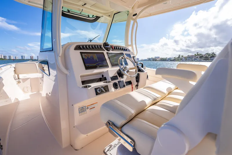 Slide: The Image of 2023 Grady-White 336 Canyon boat interior with modern dashboard and seating. - 36