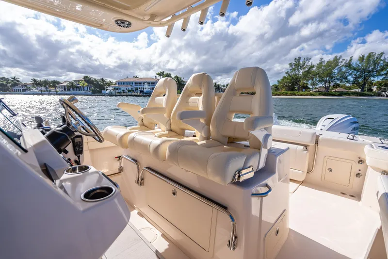 Slide: The Image of 2023 Grady-White 336 Canyon boat interior with luxurious seating and scenic water view. - 38