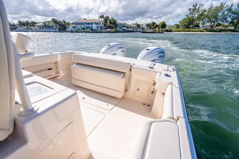 Slide: The Image of 2023 Grady-White 336 Canyon boat on water, featuring dual Yamaha engines. - 39