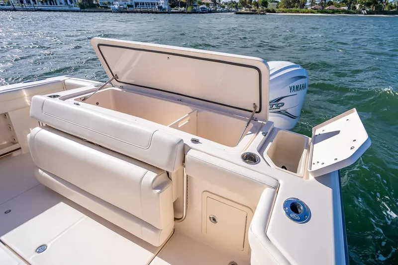 Slide: The Image of 2023 Grady-White 336 Canyon boat with open storage compartments on the deck. - 40