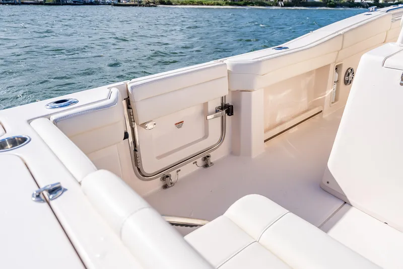 Slide: The Image of 2023 Grady-White 336 Canyon boat interior with open side door, near water. - 46