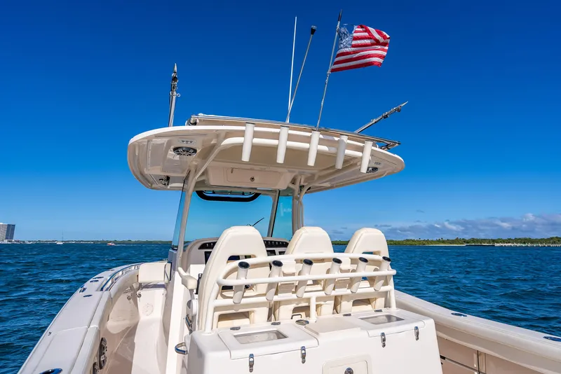 Slide: The Image of 2023 Grady-White 336 Canyon boat on open water with American flag. - 49