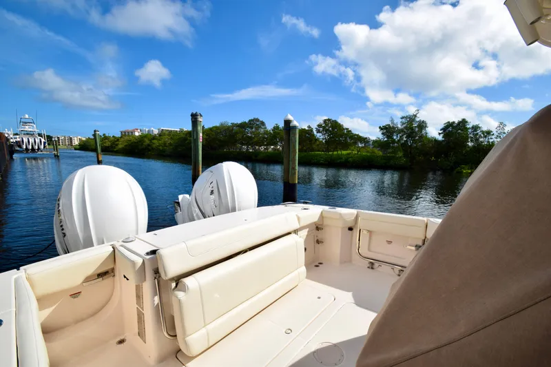 Slide: The Image of 2023 Grady-White 336 Canyon boat docked on a sunny day, featuring dual engines. - 63