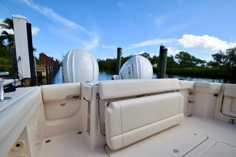 Slide: The Image of 2023 Grady-White 336 Canyon boat interior with dual outboard engines at dock. - 66