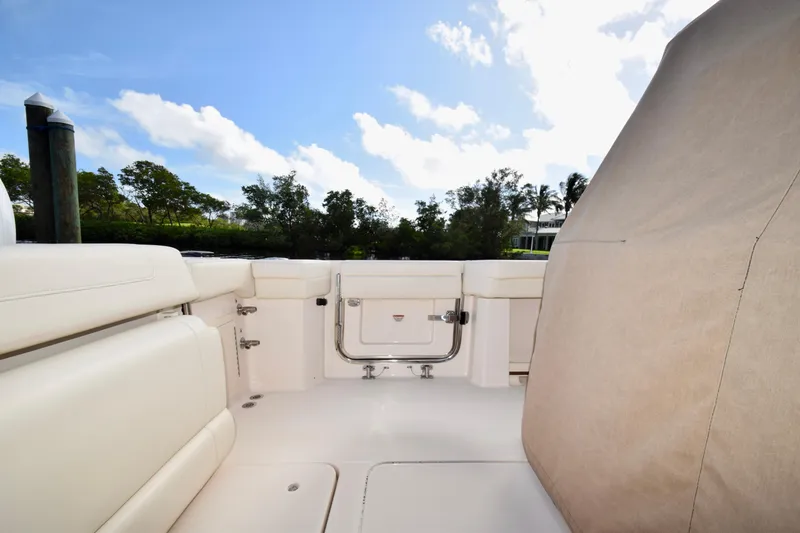 Slide: The Image of 2023 Grady-White 336 Canyon boat interior with white seating and clear sky. - 67