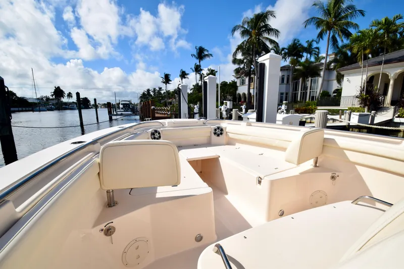 Slide: The Image of 2023 Grady-White 336 Canyon boat docked in a sunny marina with palm trees. - 70