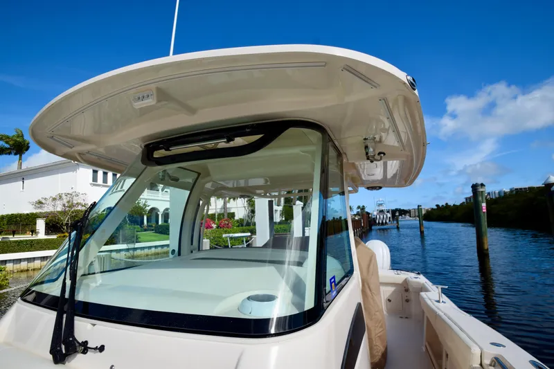 Slide: The Image of 2023 Grady-White 336 Canyon boat docked by a scenic waterfront. - 71