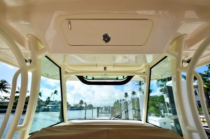 Slide: The Image of Interior view of 2023 Grady-White 336 Canyon boat, showcasing helm and windows. - 74