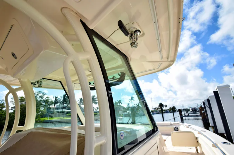 Slide: The Image of 2023 Grady-White 336 Canyon boat with clear skies and waterfront view. - 75