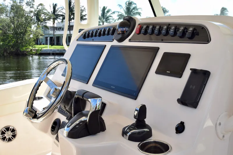 Slide: The Image of 2023 Grady-White 336 Canyon boat dashboard with modern controls and navigation screens. - 79
