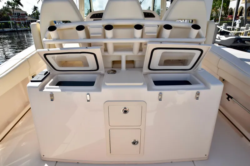 Slide: The Image of 2023 Grady-White 336 Canyon boat with open storage compartments and rod holders. - 80