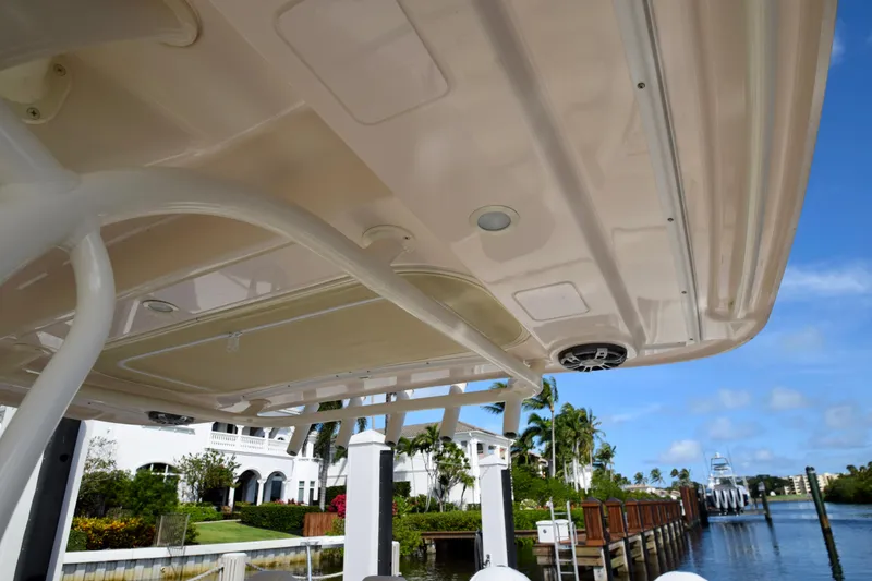 Slide: The Image of 2023 Grady-White 336 Canyon boat canopy with scenic marina backdrop. - 81