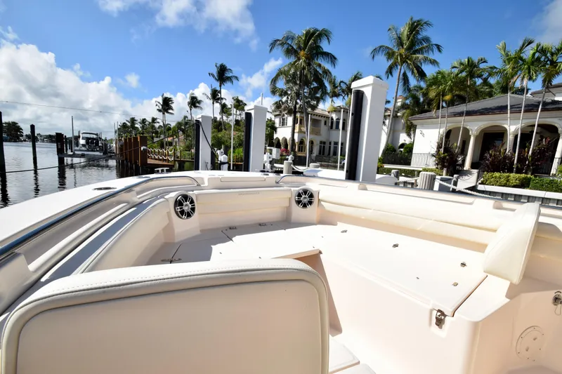 Slide: The Image of 2023 Grady-White 336 Canyon boat docked near luxury waterfront homes. - 85