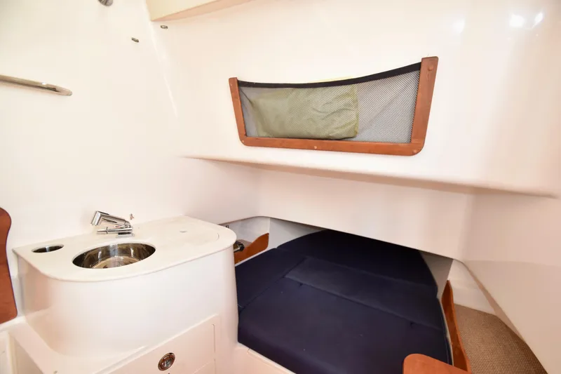 Slide: The Image of 2023 Grady-White 336 Canyon cabin interior with sink and sleeping area. - 88