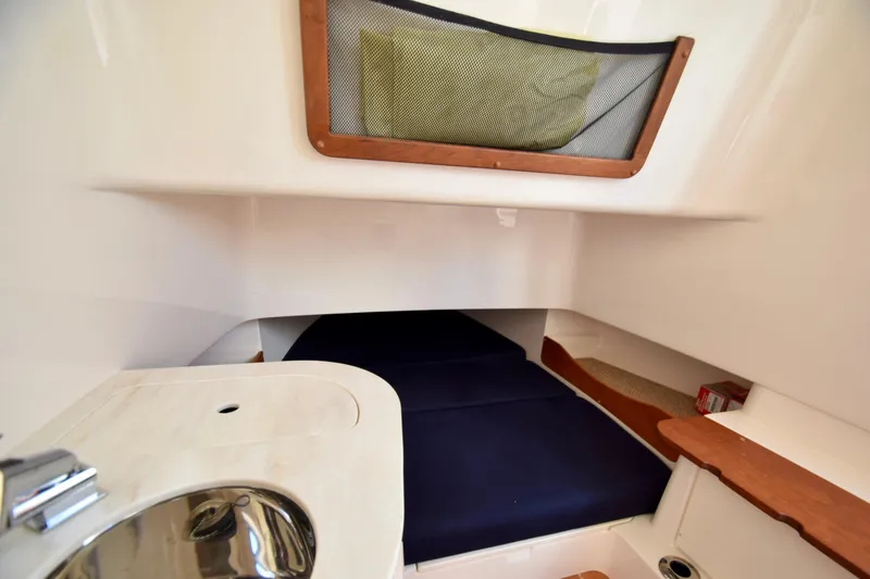 Slide: The Image of 2023 Grady-White 336 Canyon cabin interior with sink and storage. - 90