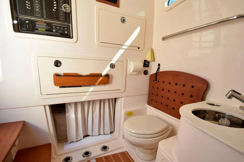 Slide: The Image of 2023 Grady-White 336 Canyon boat interior with toilet and sink. - 91