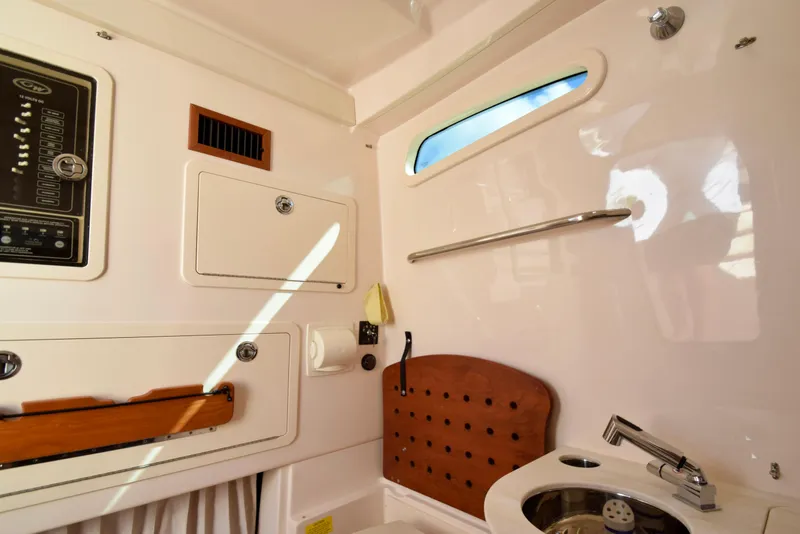 Slide: The Image of Interior of 2023 Grady-White 336 Canyon boat, featuring sink and storage compartments. - 92