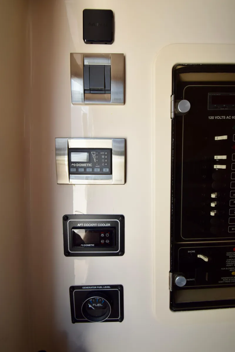 Slide: The Image of Control panel of 2023 Grady-White 336 Canyon boat with various switches and gauges. - 96