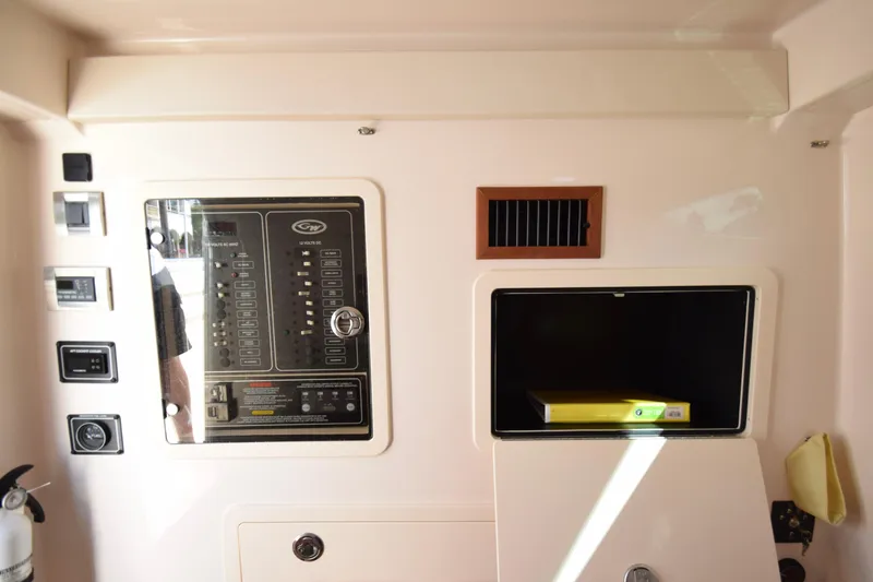 Slide: The Image of 2023 Grady-White 336 Canyon control panel and storage compartment interior. - 97