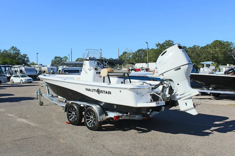 Slide: The Image of 2025 NauticStar 214 Shallow Bay boat on trailer in parking lot. - 10